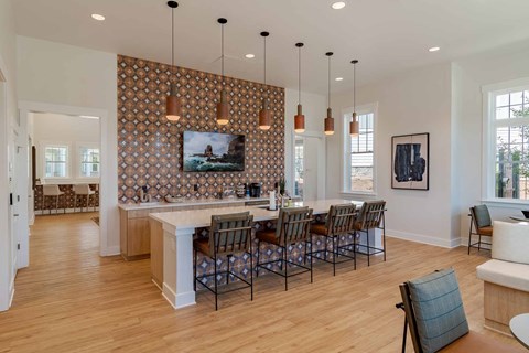 A kitchen with a dining table and chairs.