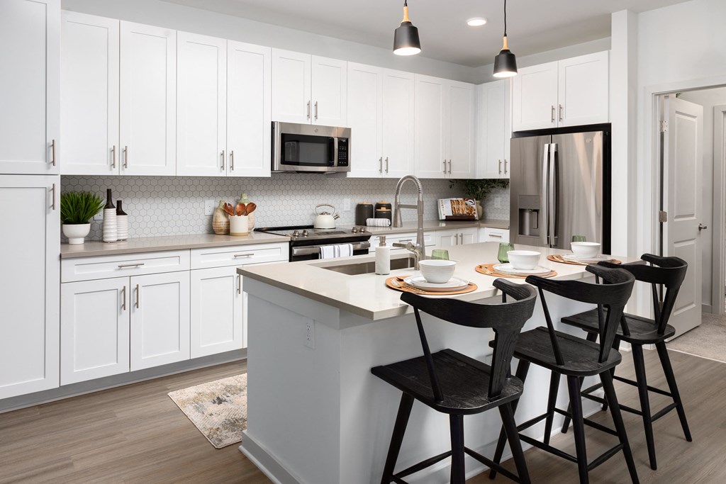 a kitchen with a center island and three stools