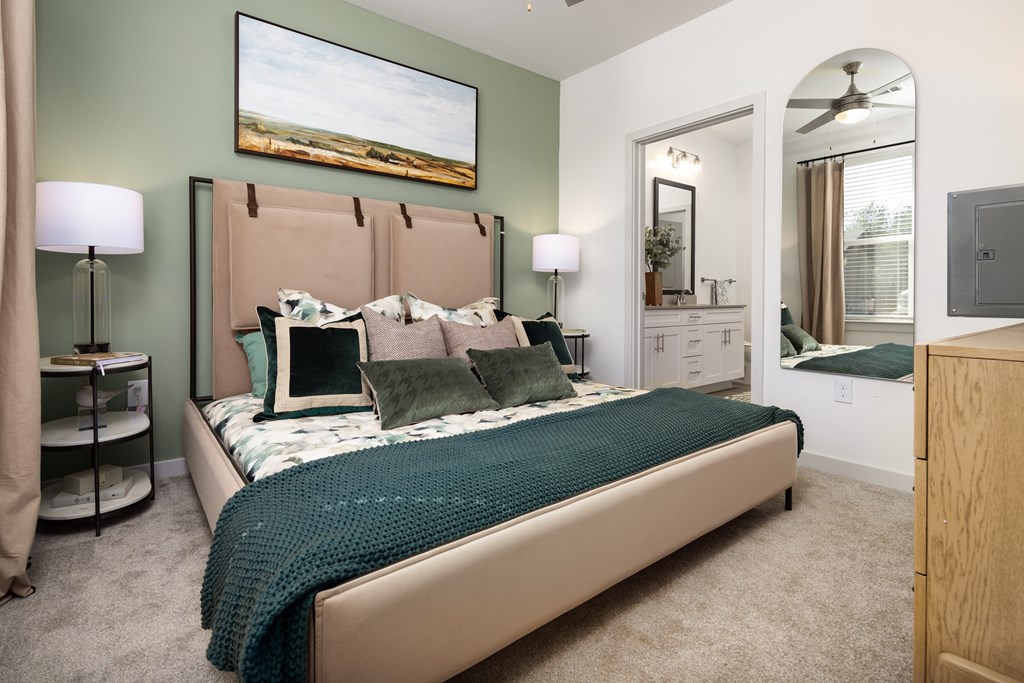 a bedroom with a bed and a mirror in a house