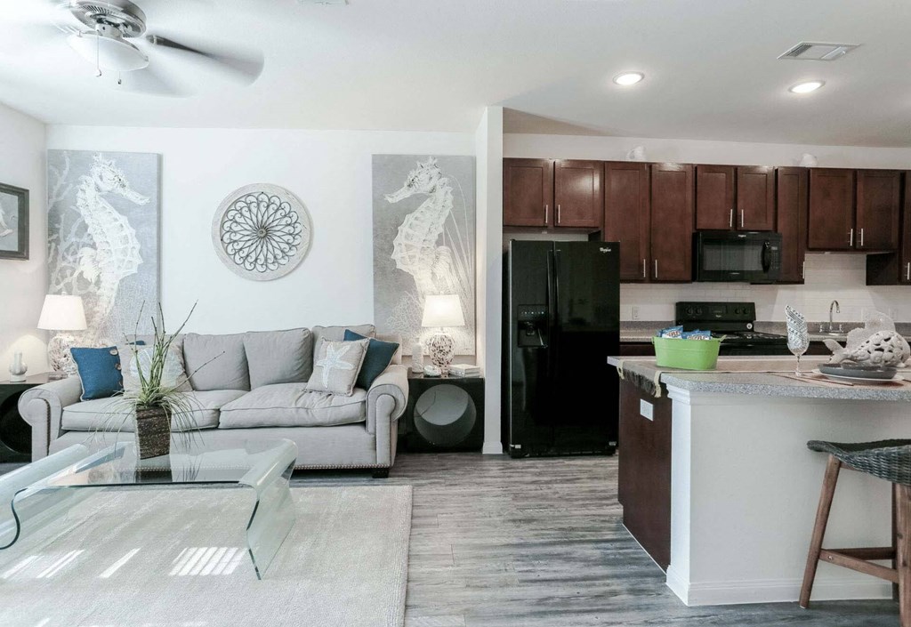 a living room and kitchen with a couch and a table