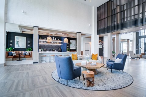 A modern living room with a blue chair and a coffee table.