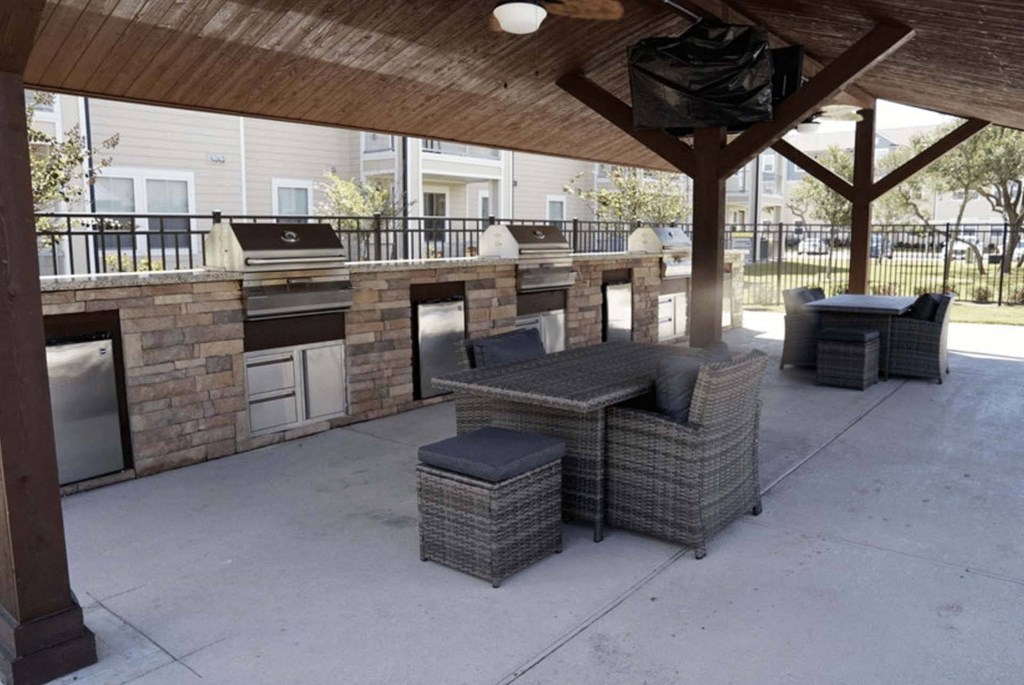 a covered patio with furniture and a bar