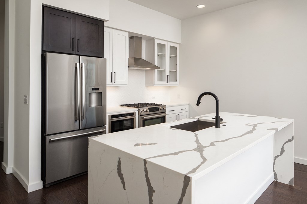 a kitchen with an island and stainless steel appliances