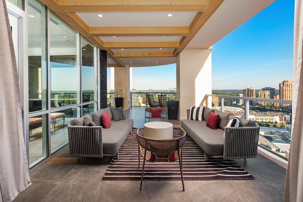 a living room filled with furniture and a large window