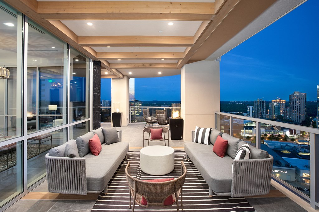 a living room filled with furniture and a large window