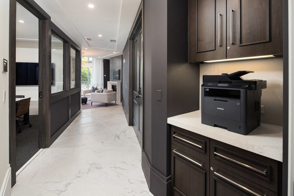 a kitchen with dark cabinets and white countertops
