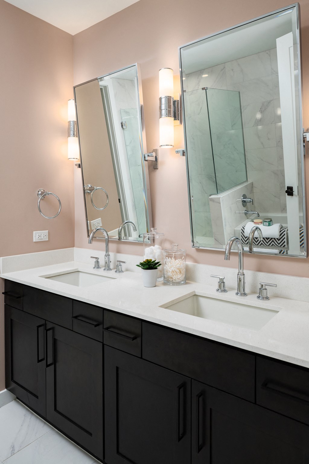 a bathroom with two sinks and two mirrors