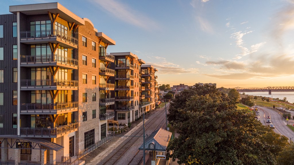 an aerial view of a city with train tracks and buildings