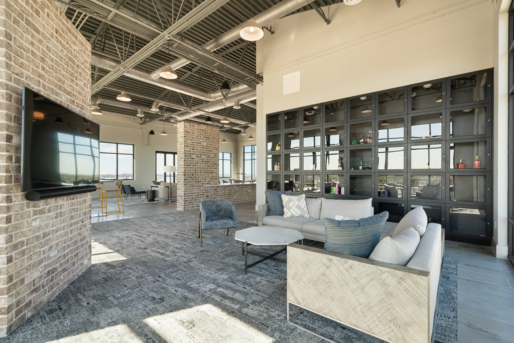 a living room with a couch and chairs and a television