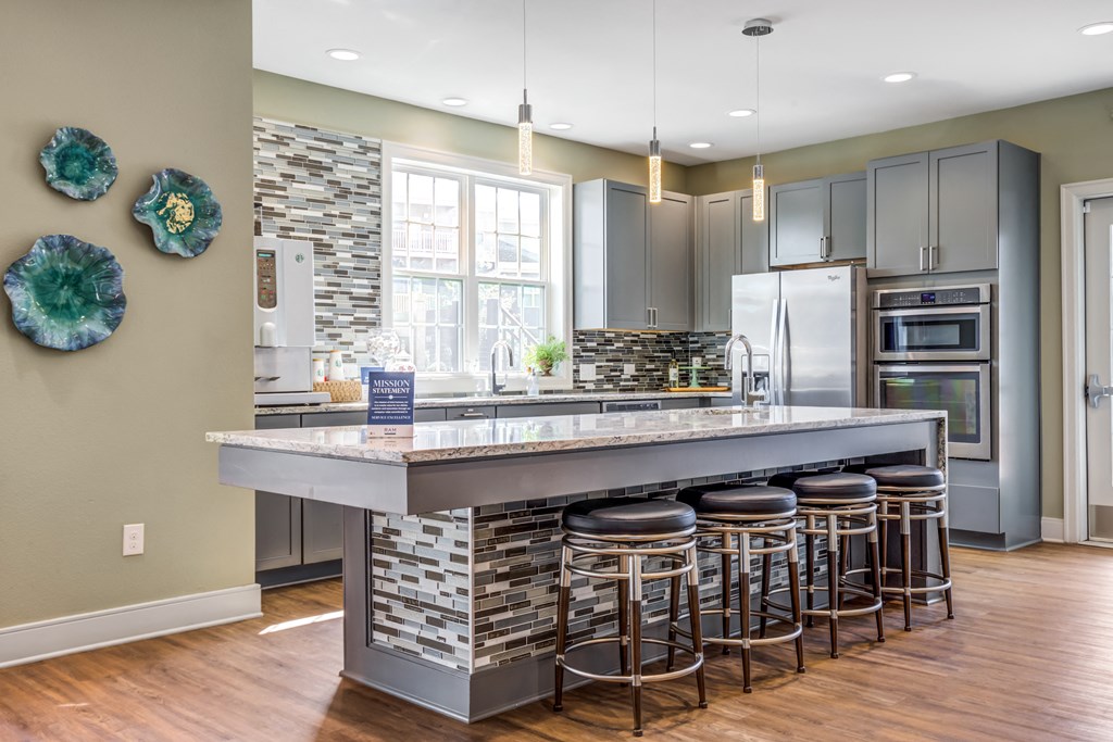 a kitchen with a large island with bar stools