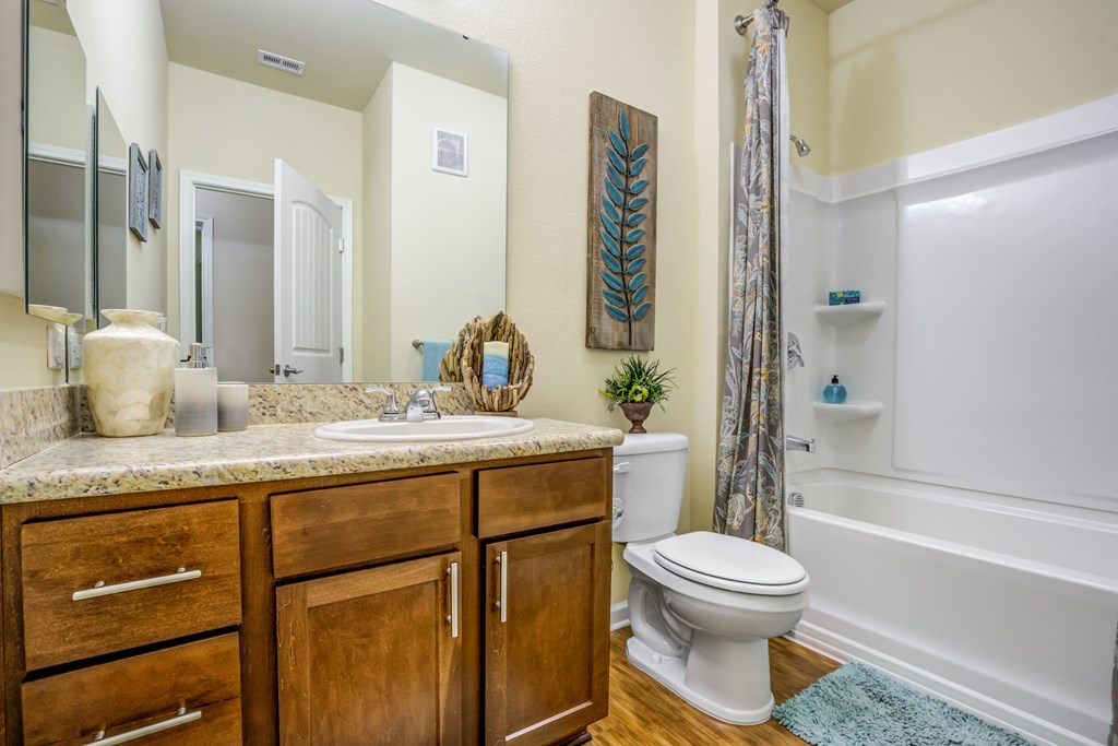 a bathroom with a toilet and a sink and a shower