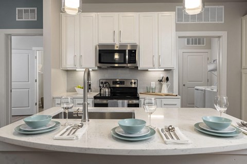 a white kitchen with white cabinets and a white counter top