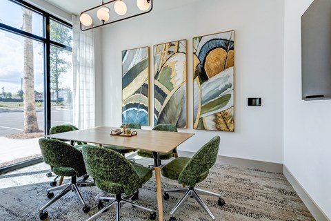 A conference room with a long table and chairs.