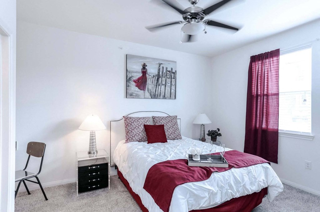 a bedroom with a bed and a ceiling fan
