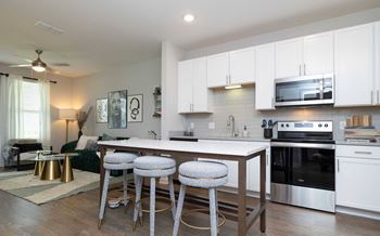 A kitchen with white cabinets and a stainless steel oven.