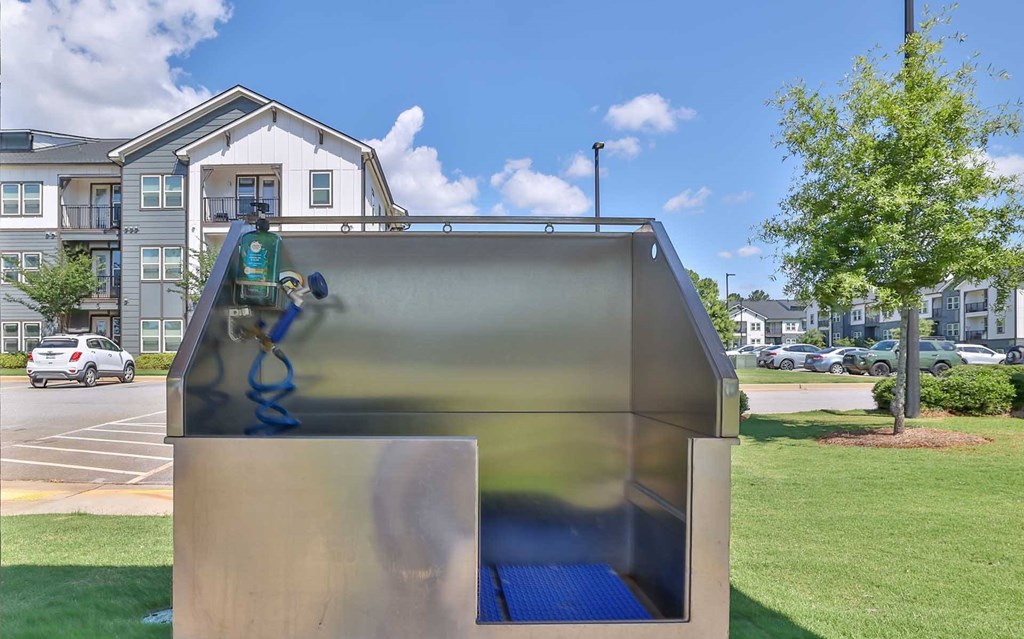 A playground with a slide and a blue mat.