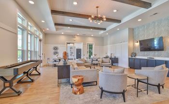 A spacious living room with a pool table and comfortable seating.