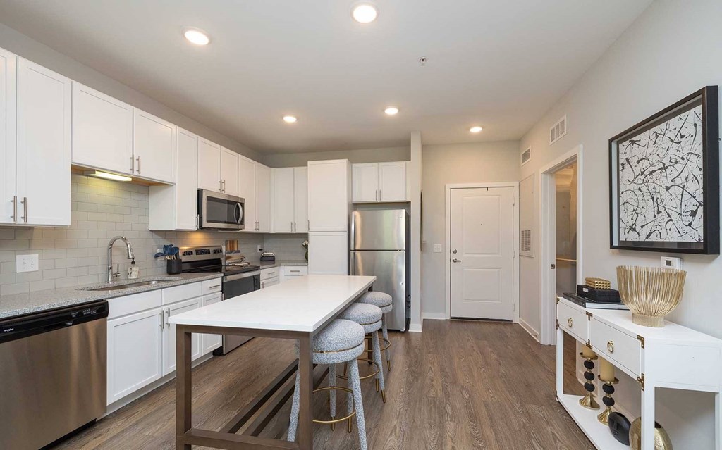 A modern kitchen with a dining table and chairs.