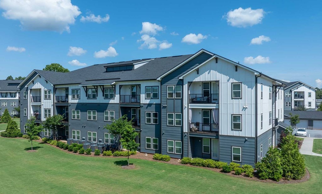 A large apartment complex with multiple buildings and green lawns.