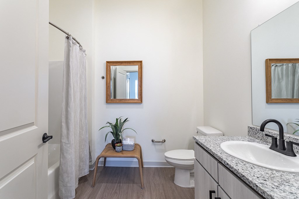 a bathroom with a toilet sink and shower