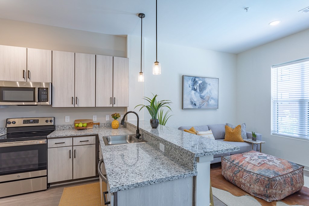 a kitchen with granite countertops and stainless steel appliances