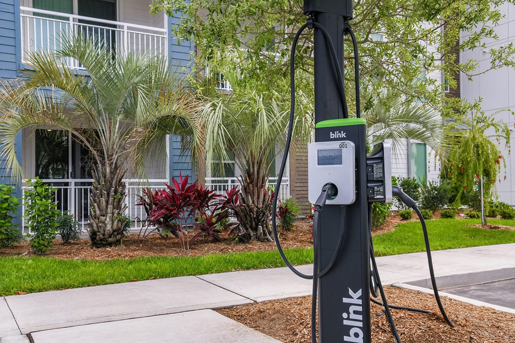 an electric charger on a pole in front of a building