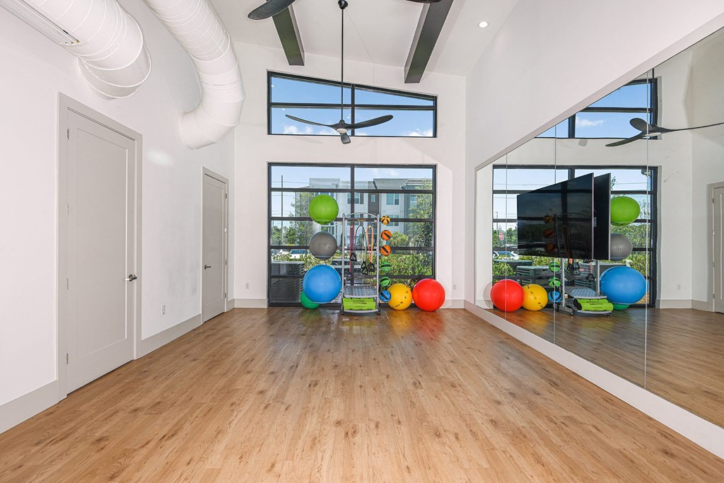 a large room with hardwood floors and large windows