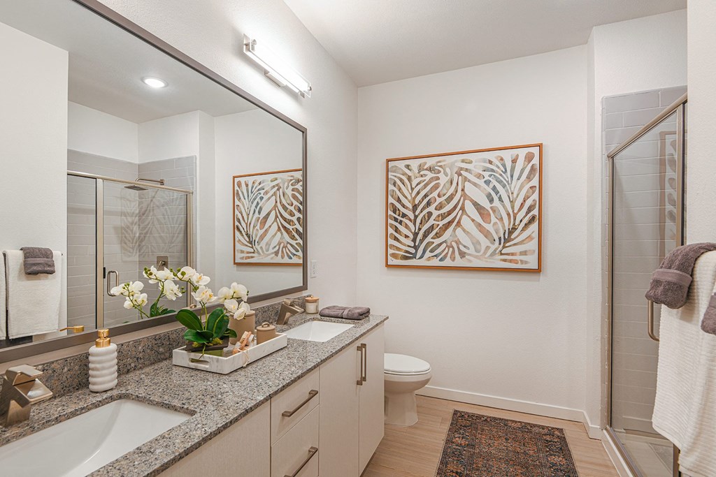 a bathroom with a large mirror and two sinks