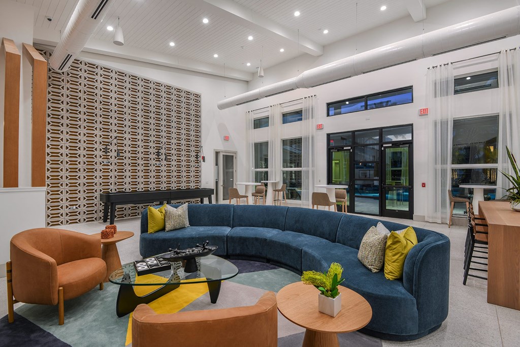 a living room filled with furniture and a large window