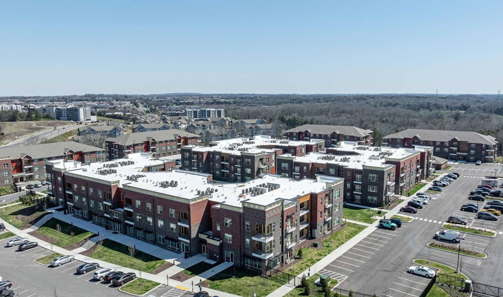 A large apartment complex with multiple buildings and parking lots.