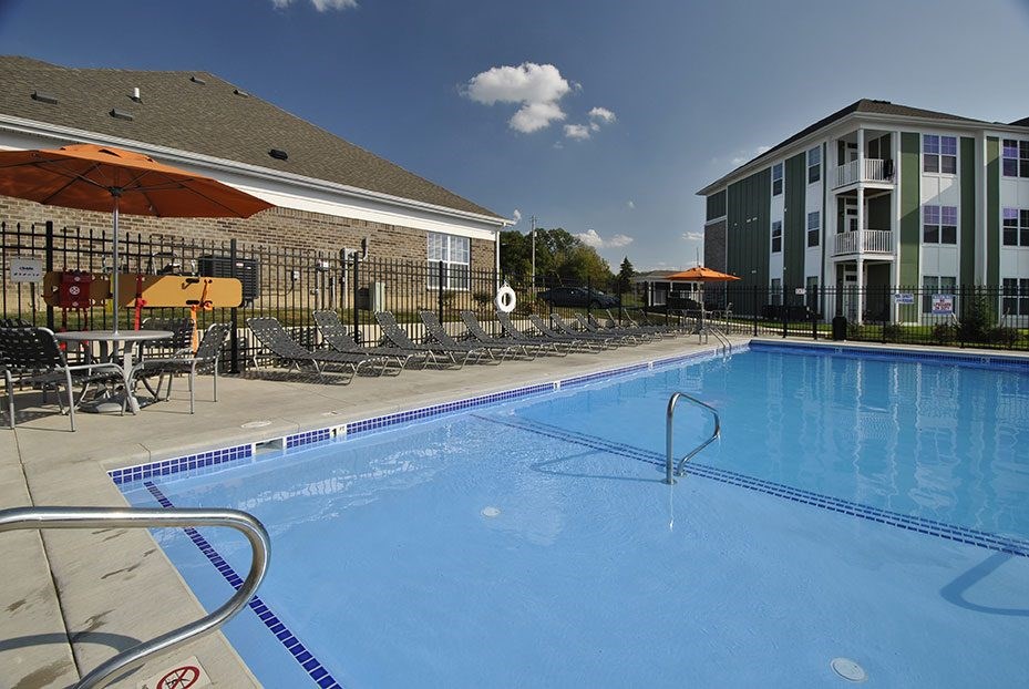 A swimming pool with a metal ladder in the middle of it.