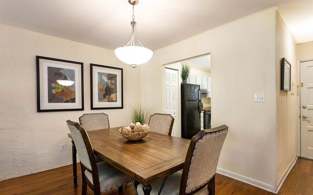 A dining room with a wooden table and chairs at Legacy, Tampa, FL, 33603