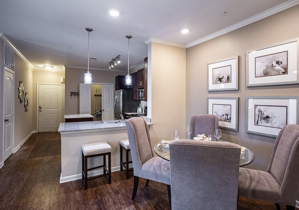 a dining room and kitchen with a table and chairs