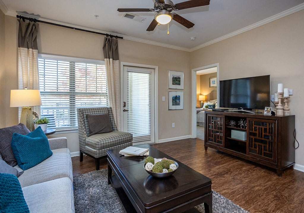 a living room with a couch and a coffee table and a tv