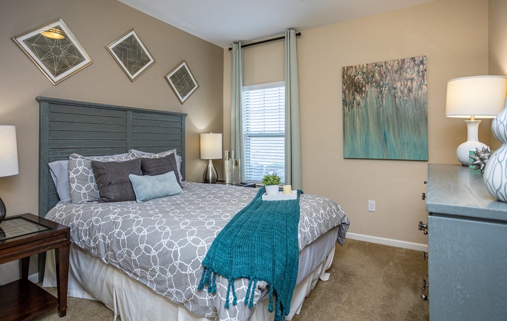 a bedroom with a large bed and a window