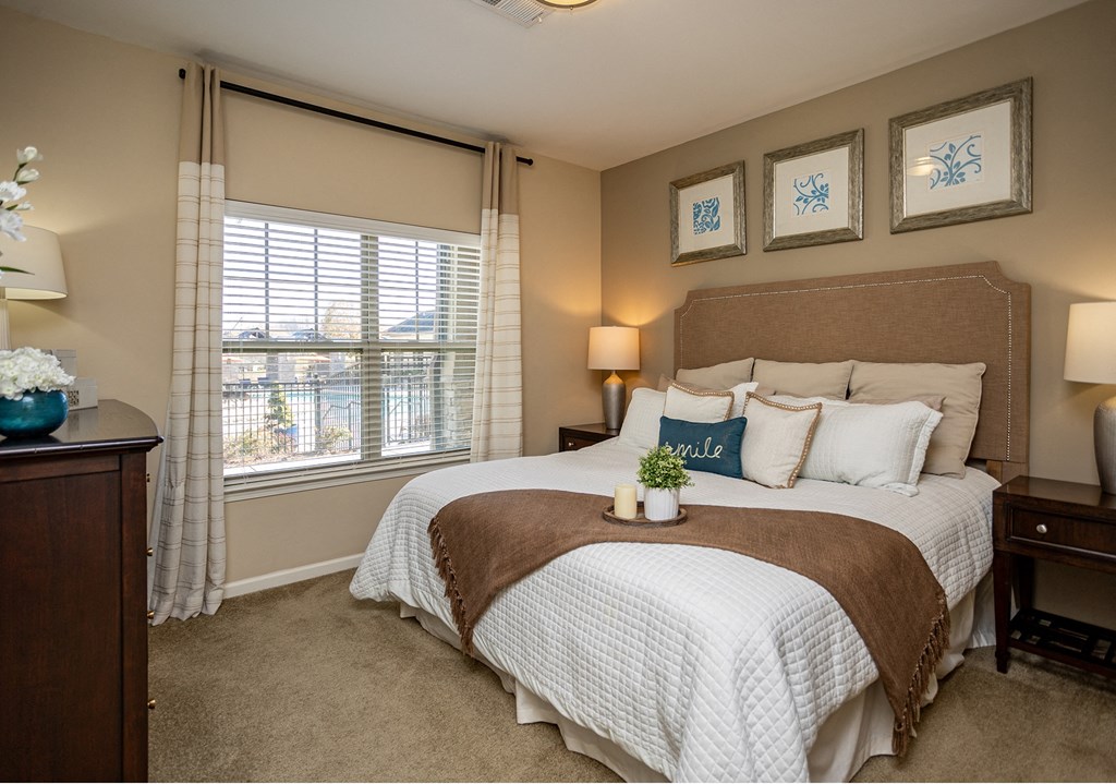 a bedroom with a large bed and a window