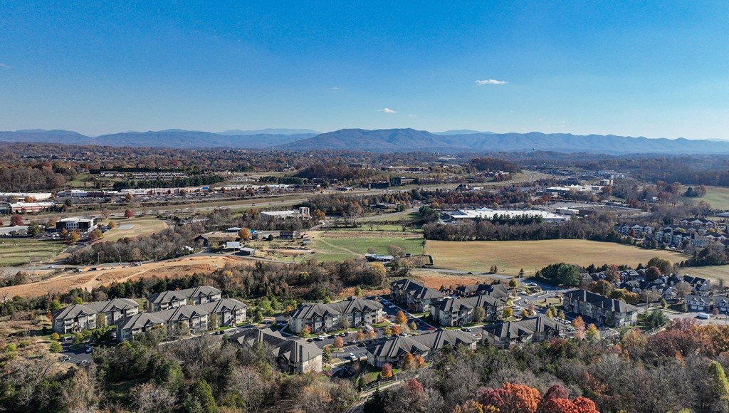 an aerial view of a city with mountains in the background
