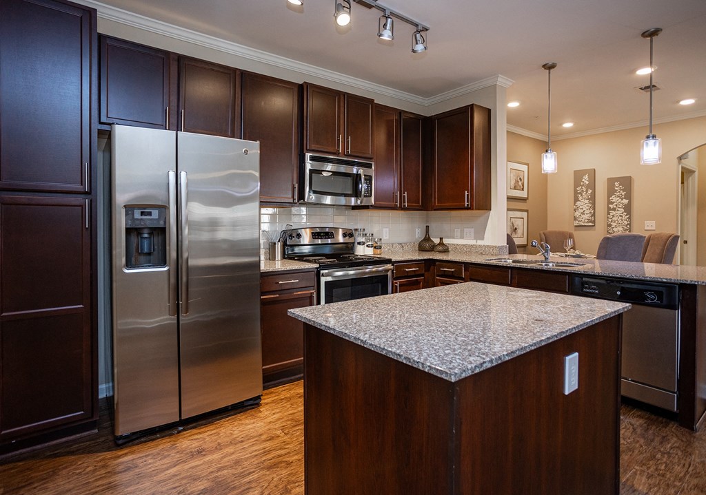 a kitchen with stainless steel appliances and granite counter tops