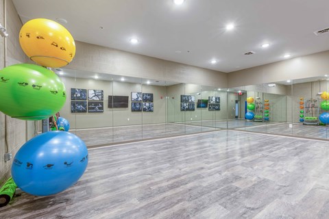 a large room with a ping pong table and a bunch of balloons