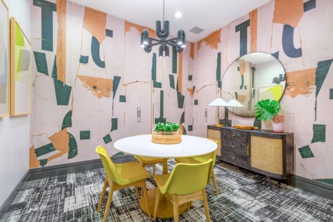 a dining room with a white table and yellow chairs