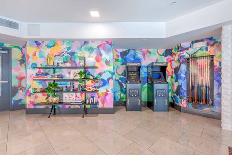 a colorful lobby with two atm machines and a bookshelf