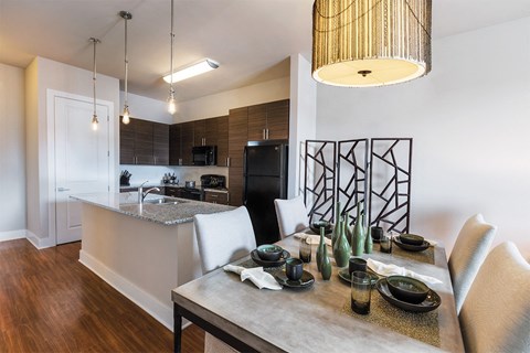 a dining room and kitchen with a table and chairs