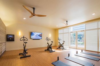the vue beachwood exercise room with yoga mats and stationary bikes