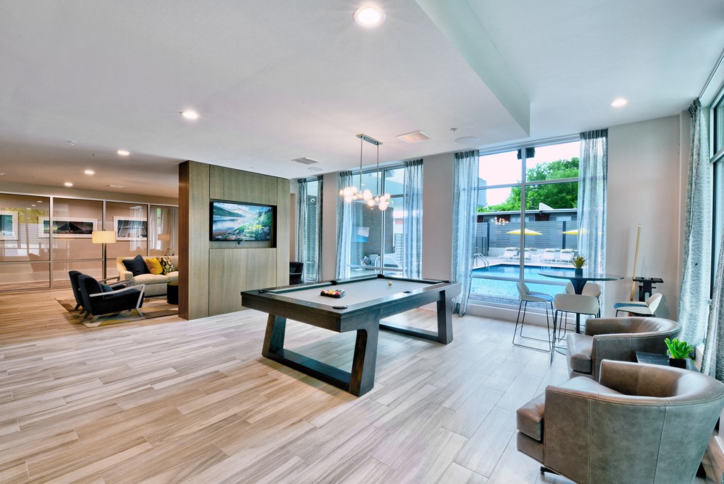 a living room with a pool table in the middle