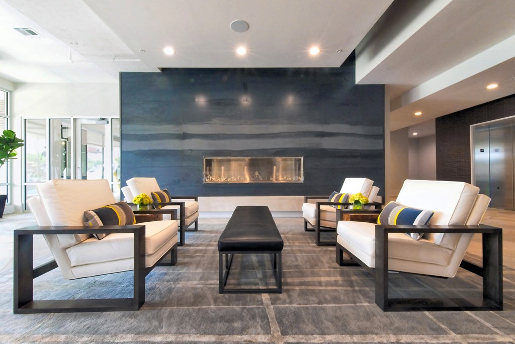 a living room with couches and chairs and a fireplace