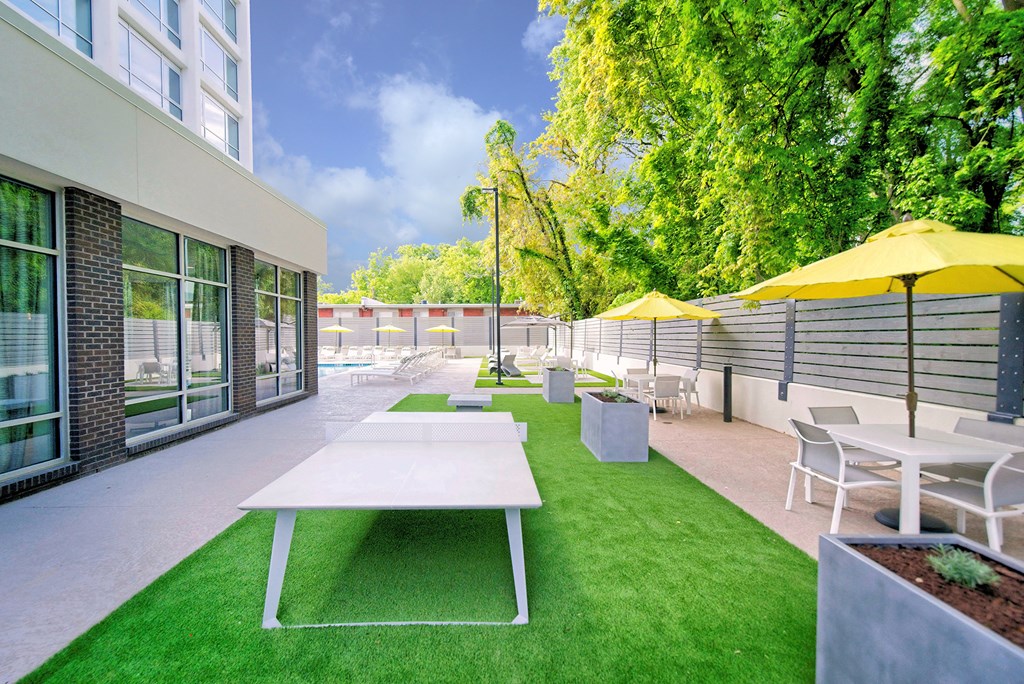 a patio with tables and chairs and umbrellas