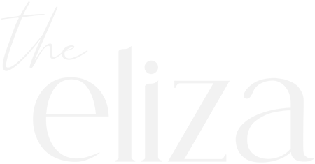 A green sign with the word "the eliza" written in white.