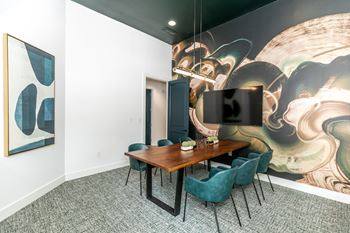 A conference room with a large table and chairs.