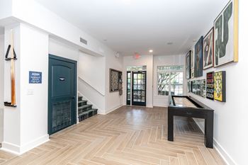 A hallway with a bench and pictures on the wall.