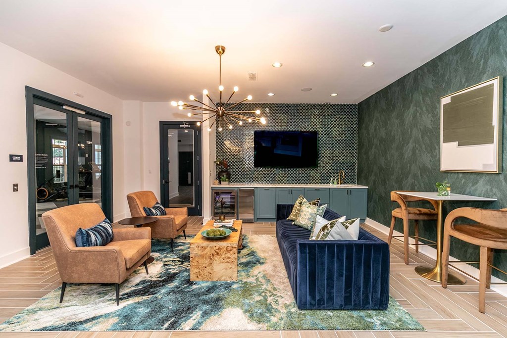 a living room with a blue couch and a tv